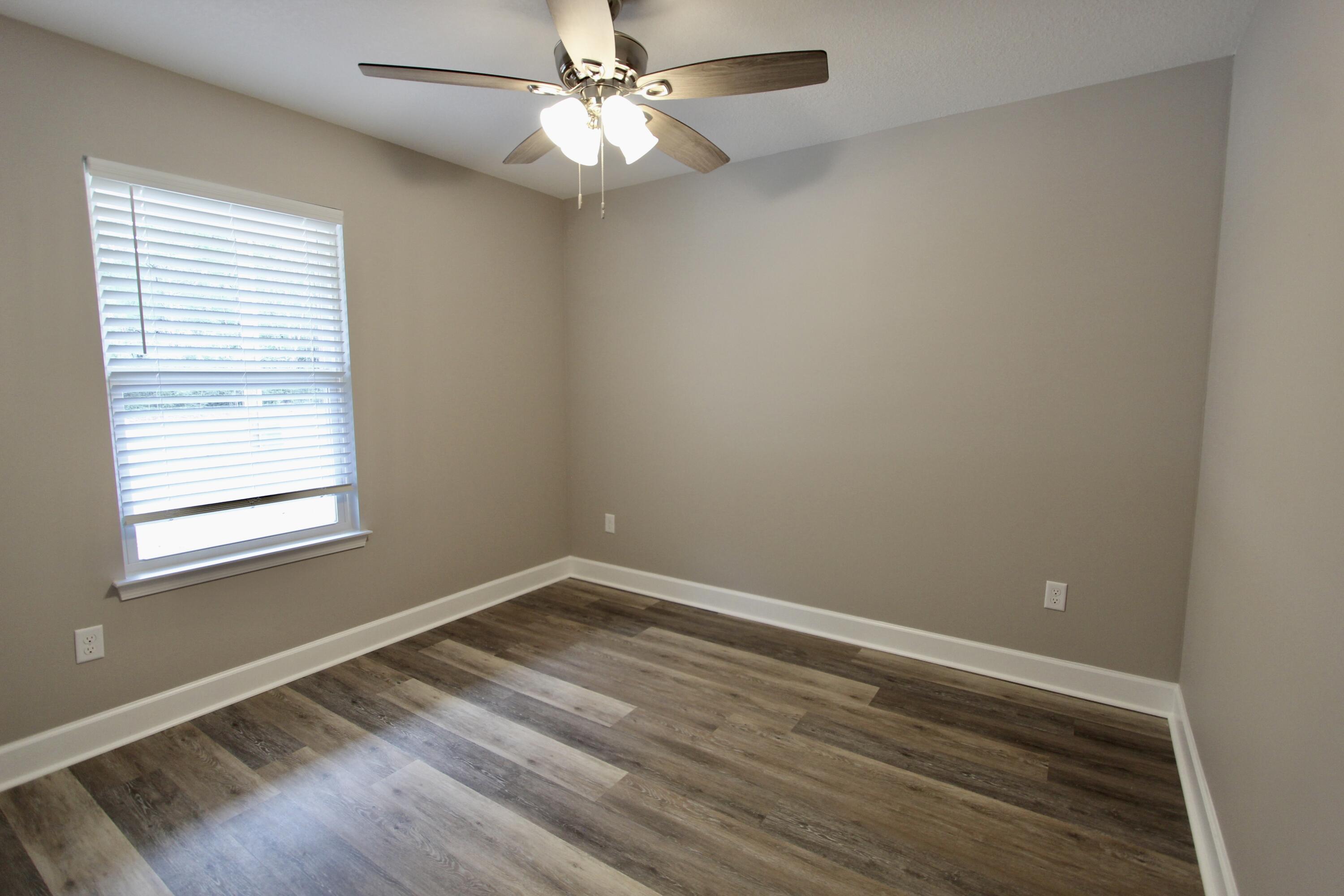 4639 Falcon Way Crestview, FL 32539 - Photo 29 of 40 wooden floor in an empty room with a window