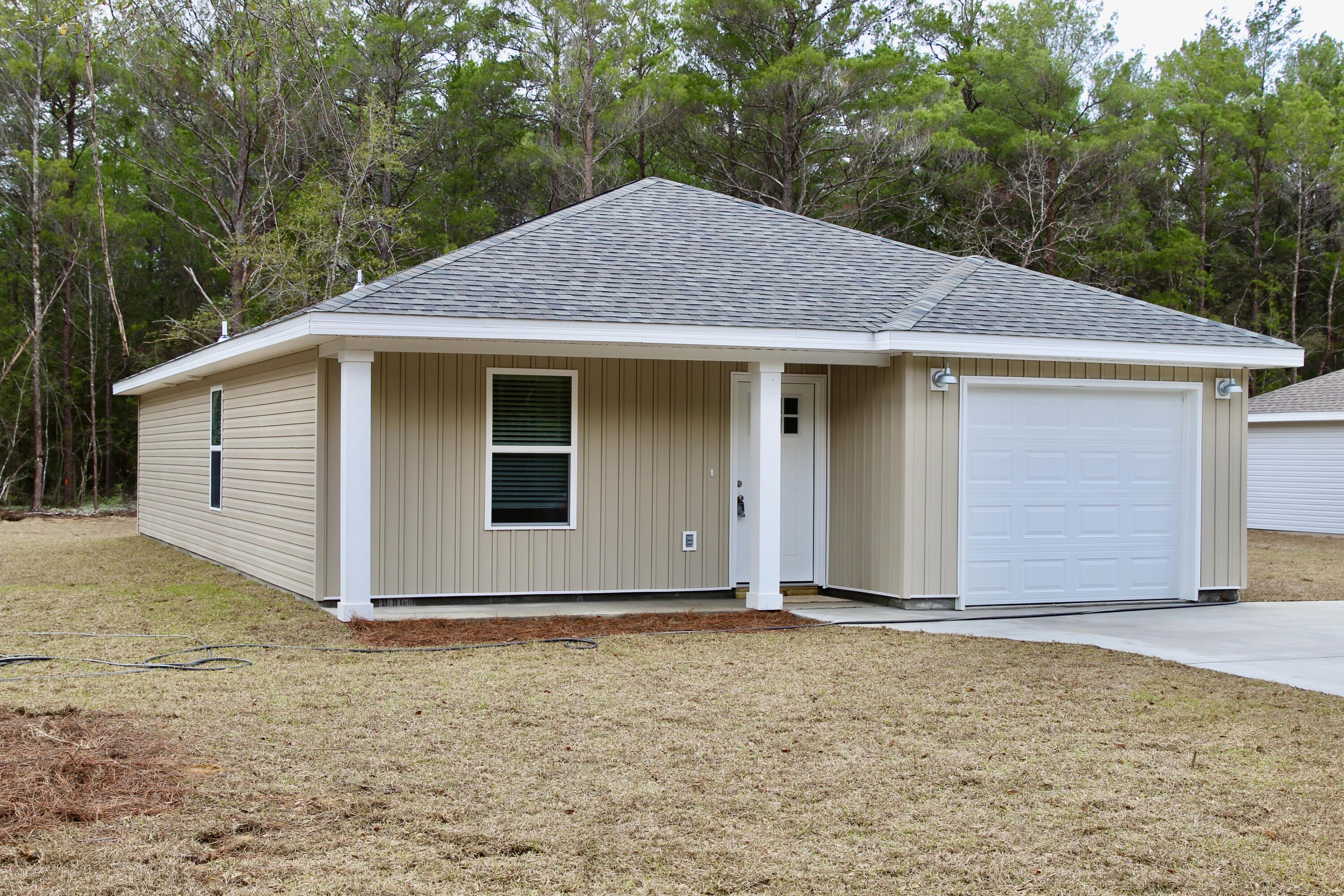 4639 Falcon Way Crestview, FL 32539 - Photo 5 of 40 a house with yard next to a yard