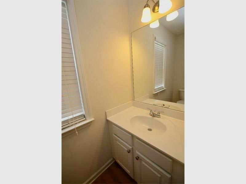 9020 Friarbridge Drive Suwanee, GA 30024 - Photo 17 of 48 a bathroom with a sink and a mirror