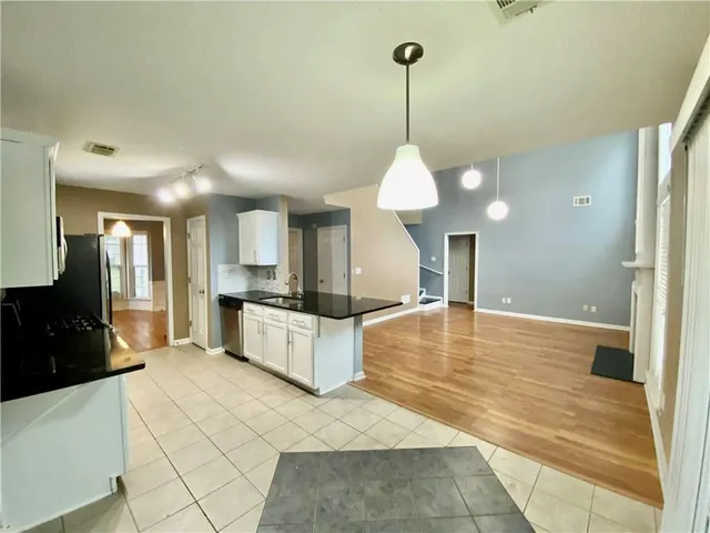 a large white kitchen with a large window