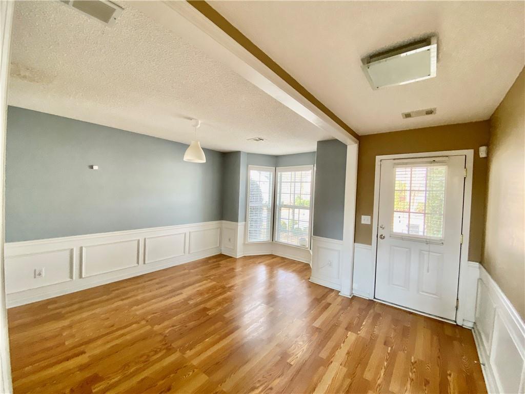 9020 Friarbridge Drive Suwanee, GA 30024 - Photo 3 of 48 a view of an empty room with window and wooden floor