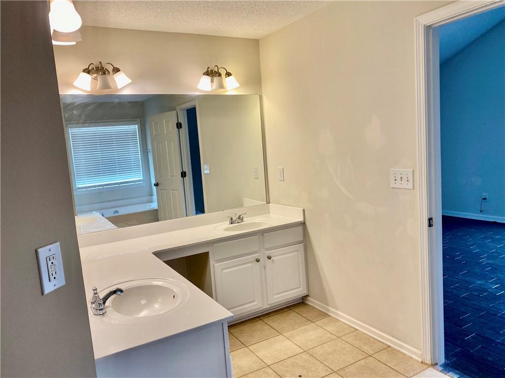 9020 Friarbridge Drive Suwanee, GA 30024 - Photo 33 of 48 a bathroom with a sink and mirror