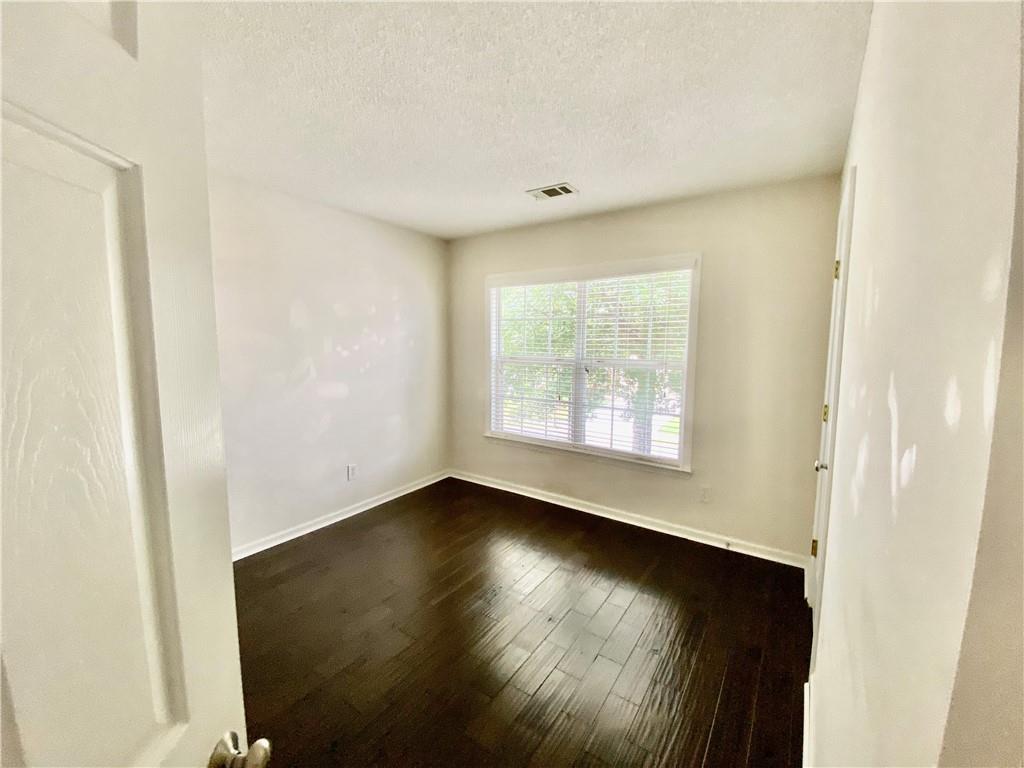 9020 Friarbridge Drive Suwanee, GA 30024 - Photo 38 of 48 an empty room with wooden floor and windows