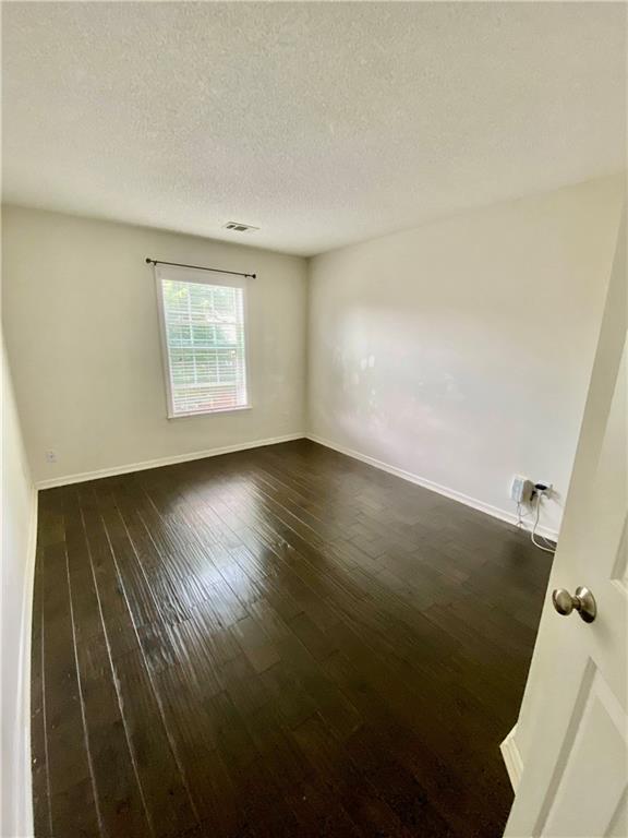 9020 Friarbridge Drive Suwanee, GA 30024 - Photo 40 of 48 an empty room with wooden floor and windows
