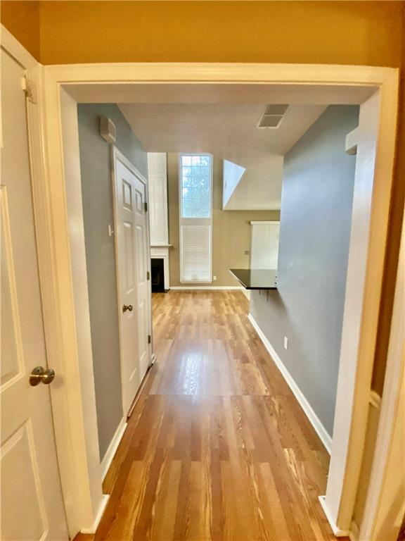 9020 Friarbridge Drive Suwanee, GA 30024 - Photo 4 of 48 a view of a hallway with wooden floor and staircase