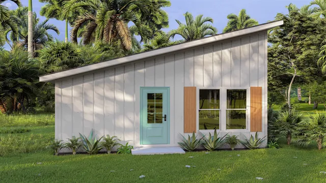 a couple of potted plants in front of door with wooden fence