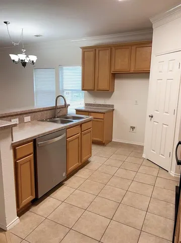 a kitchen with a sink cabinets and appliances