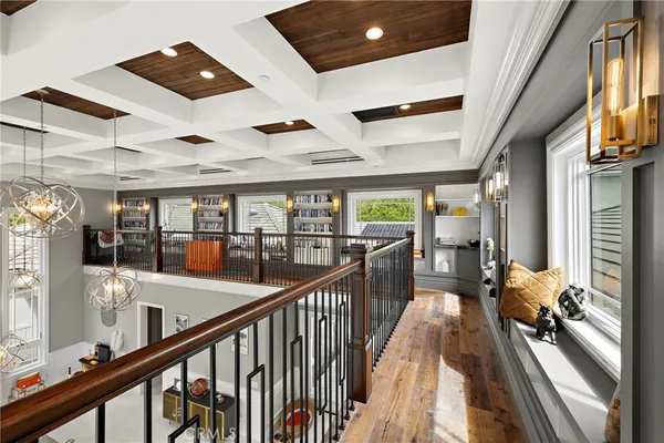 a dining room with wooden floor and stainless steel appliances