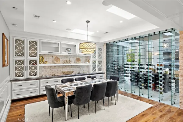 a bathroom with double vanity sinks a large mirror and a bathtub