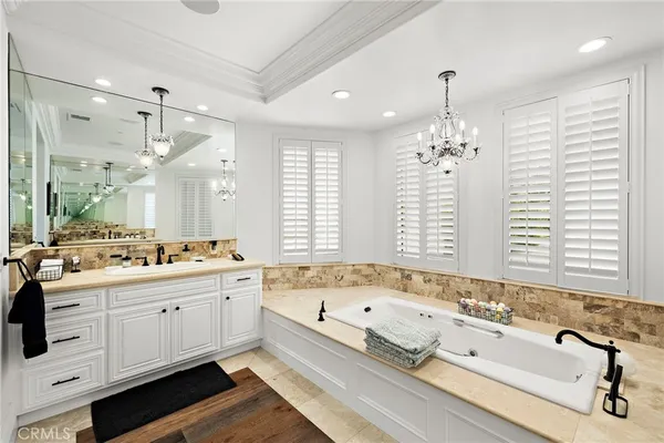a spacious bathroom with a double vanity sink and a mirror