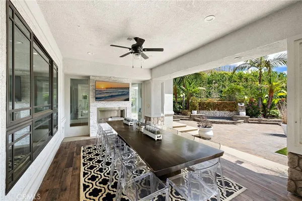 a view of a patio with couches chairs and a big yard