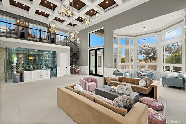 a living room with furniture and large windows