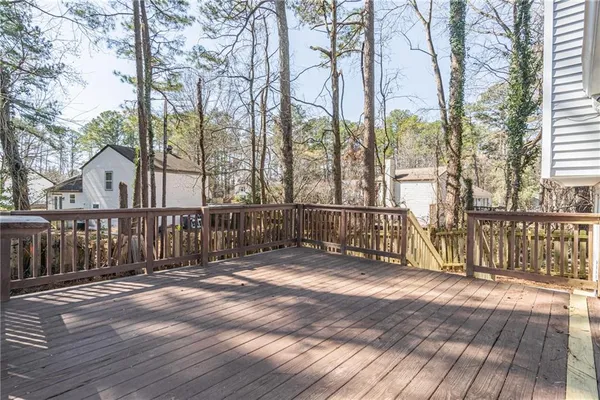 a view of a house with wooden deck and furniture