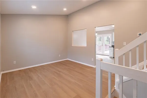a view of an empty room with wooden floor