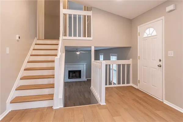 a view of a hallway with wooden floor and entryway