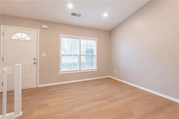 an empty room with windows and closet