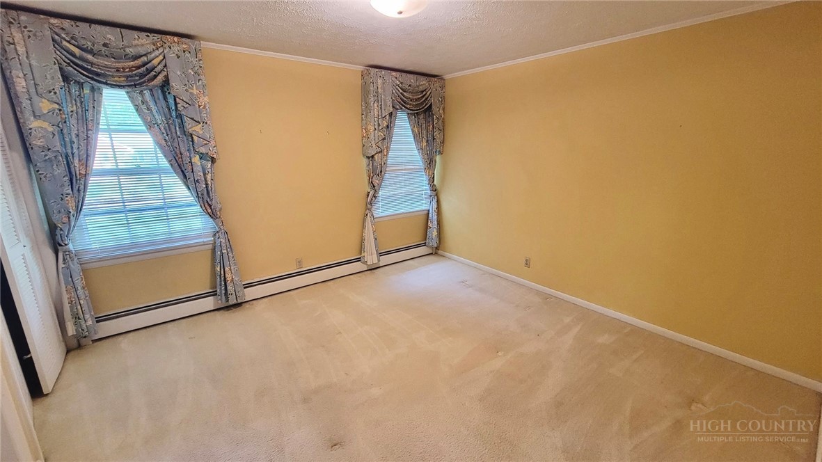 247 Crest Drive Boone, NC 28607 - Photo 13 of 19 a view of an empty room with a window
