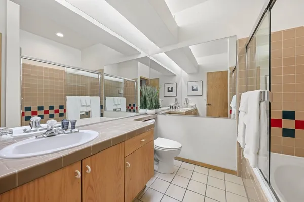 a bathroom with a sink toilet and shower