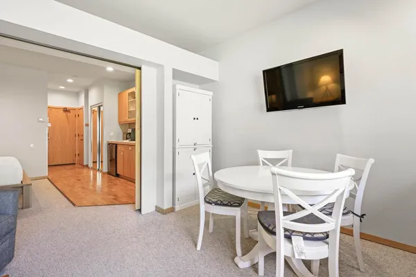 a view of a dining room with furniture and wooden floor