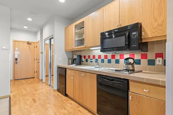 a kitchen with stainless steel appliances granite countertop a sink and a stove