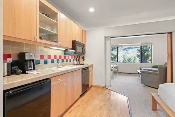 a kitchen with a sink stove and cabinets