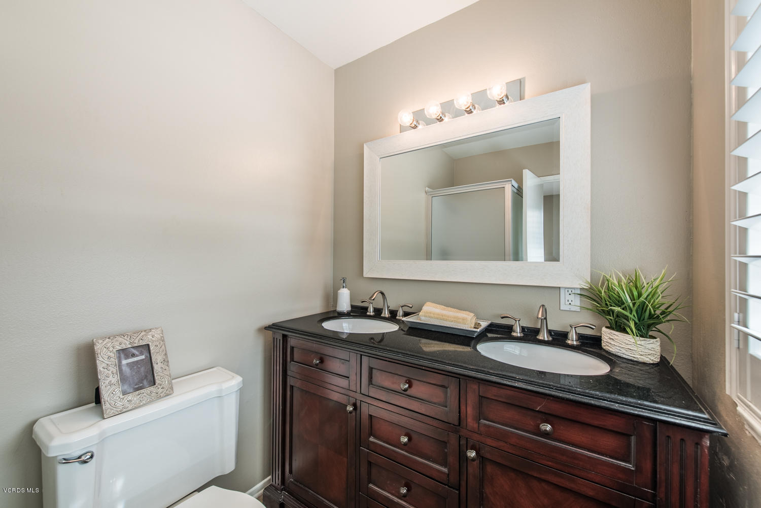 798 Appleton Road Simi Valley, CA 93065 - Photo 15 of 31 a bathroom with a granite countertop sink a mirror and a toilet