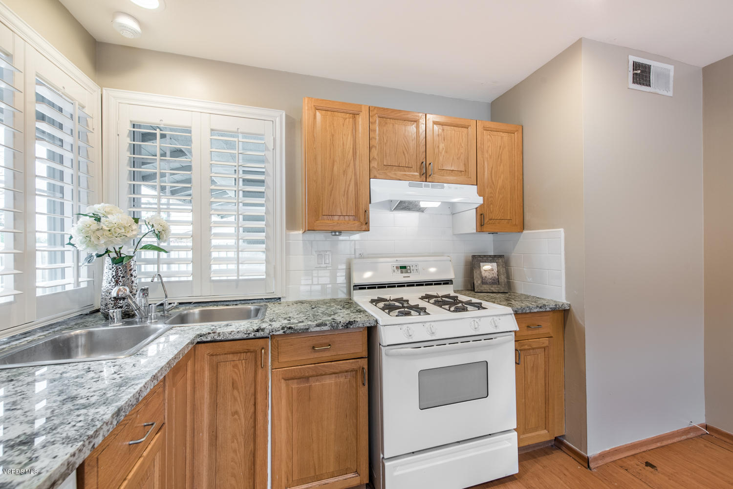 798 Appleton Road Simi Valley, CA 93065 - Photo 26 of 31 a kitchen with granite countertop a sink stove and cabinets