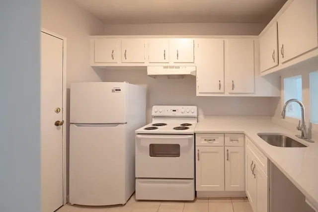a white refrigerator freezer sitting inside of a kitchen