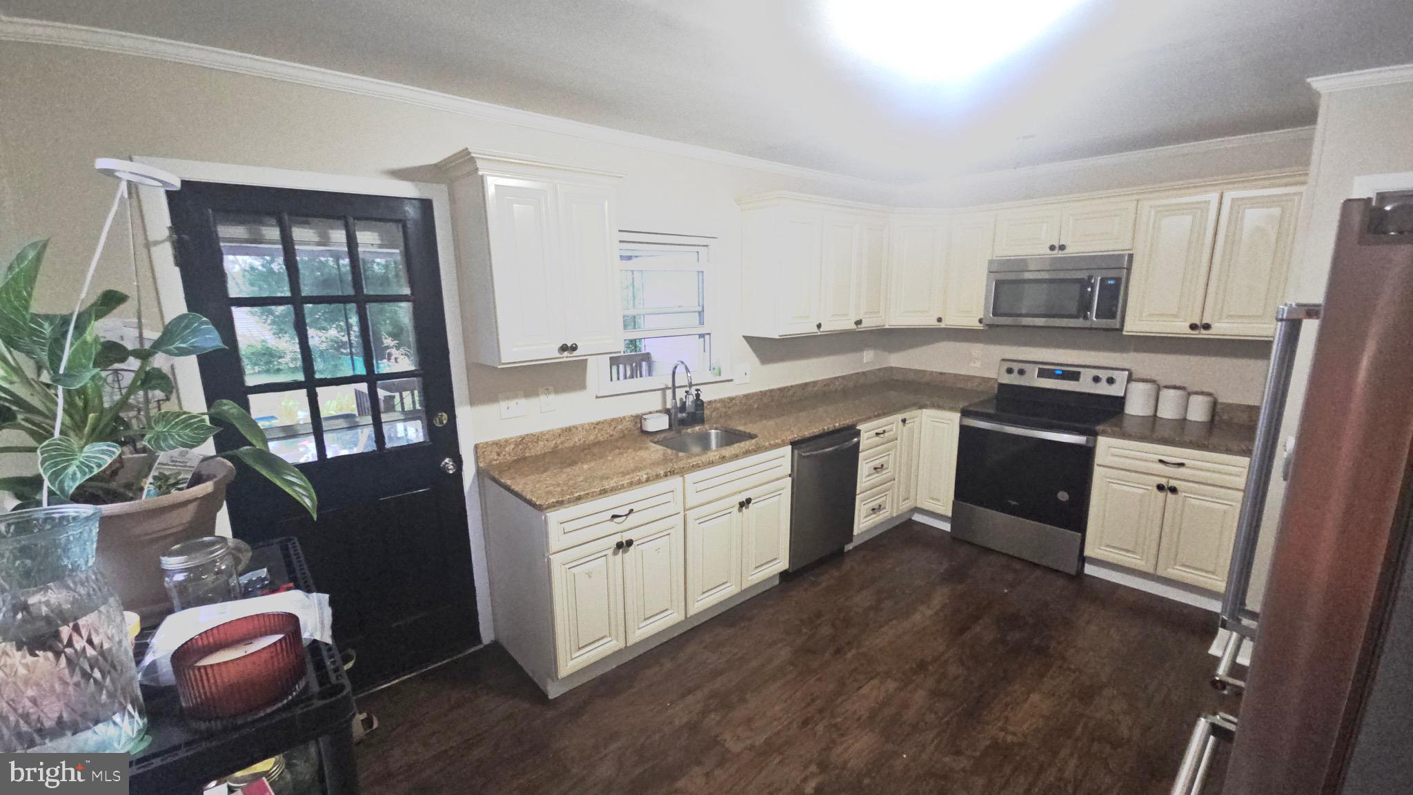 567 South Fairview Street Riverside, NJ 08075 - Photo 5 of 29 a kitchen with a sink stove and cabinets