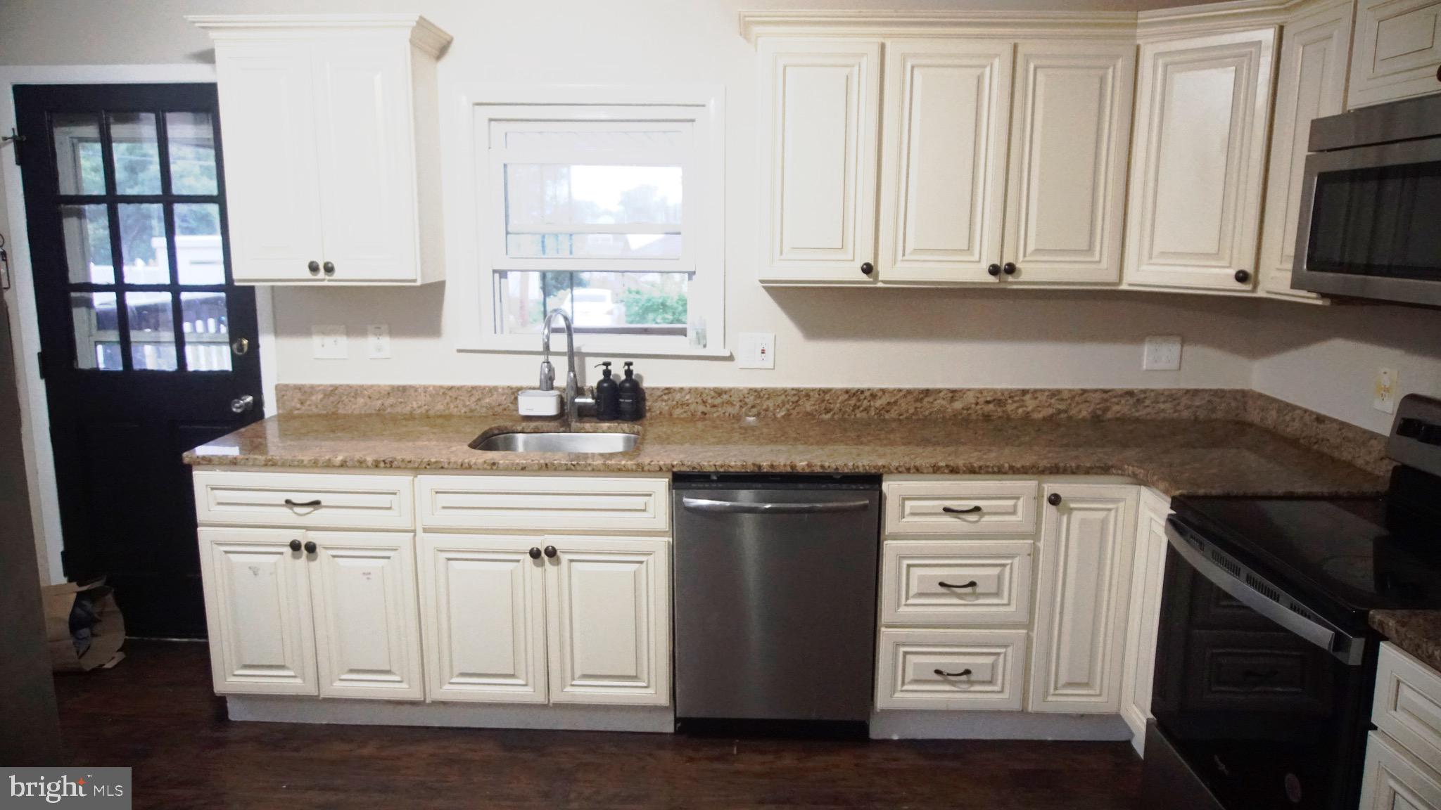 567 South Fairview Street Riverside, NJ 08075 - Photo 6 of 29 a kitchen with granite countertop white cabinets and sink