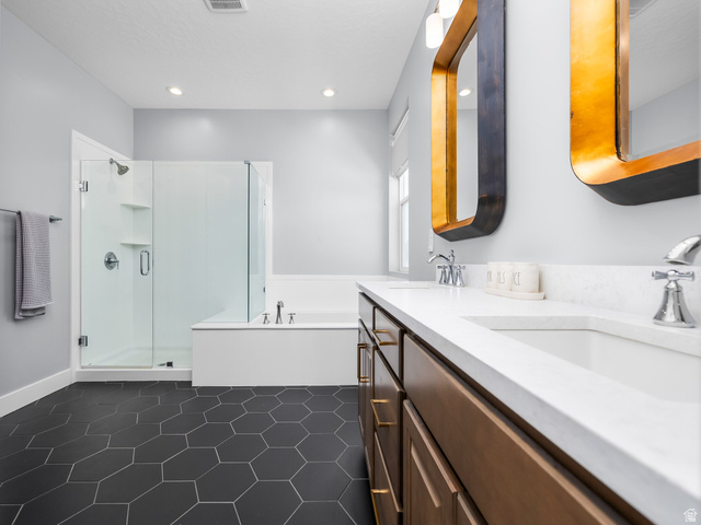 877 South Yarrow Drive Mapleton, UT 84664 - Photo 11 of 46 Dual vanity with white countertops, wood-finish cabinetry, and gold-framed mirrors