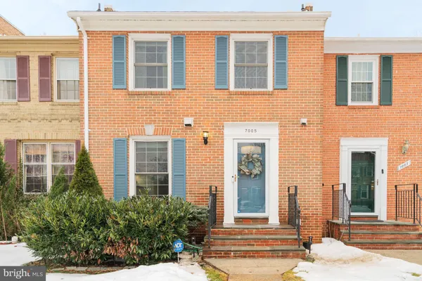 front view of a brick house with a large windows