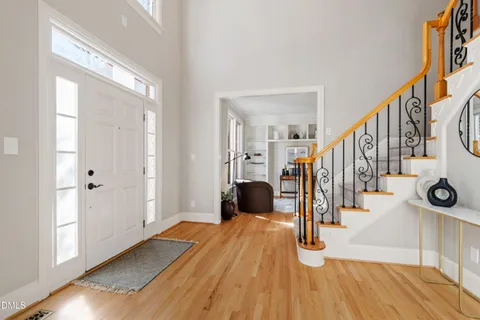 a dining room with furniture a chandelier and wooden floor