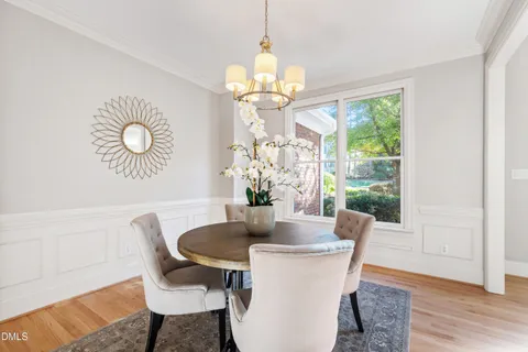 a living room with furniture a fireplace and a floor to ceiling window