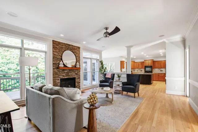 a large kitchen with a large counter top a sink stainless steel appliances and cabinets
