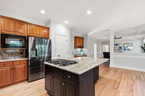 a kitchen with granite countertop a sink a counter space appliances and cabinets
