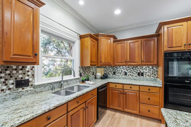 a view of kitchen with sink and refrigerator