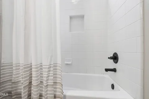 a bathroom with double vanity sink two mirror and a toilet