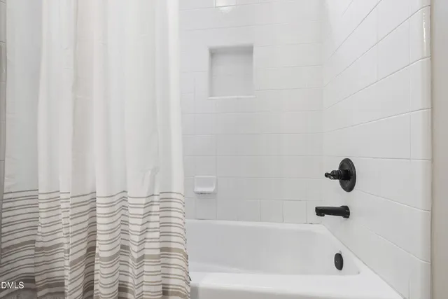 a bathroom with double vanity sink two mirror and a toilet