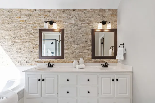 a bathroom with a double vanity sink and a mirror