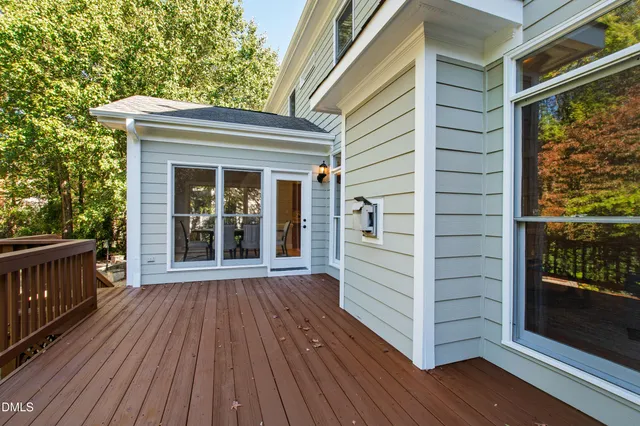 an aerial view of a houses with a lush green hillside