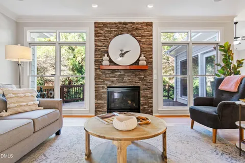 a living room with furniture a fireplace and a large window