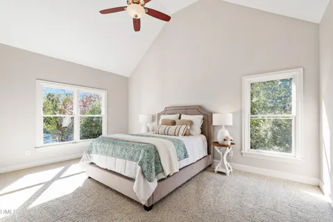 a bed sitting in a bedroom next to a window