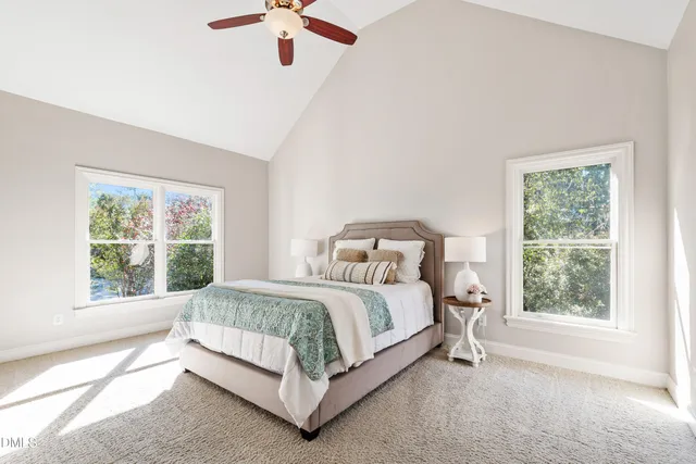 a bed sitting in a bedroom next to a window