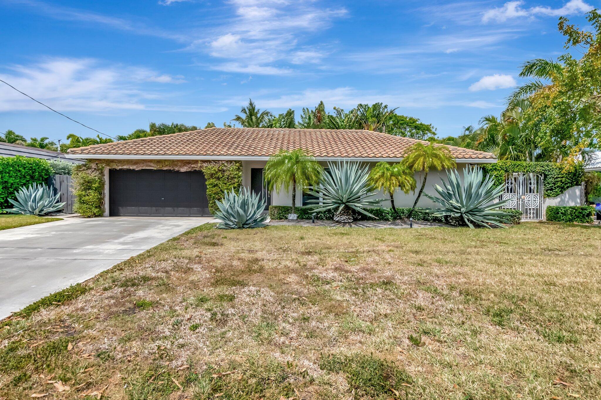 855 Berkley Street Boca Raton, FL 33487 - Photo 2 of 34 front view of a house with a yard