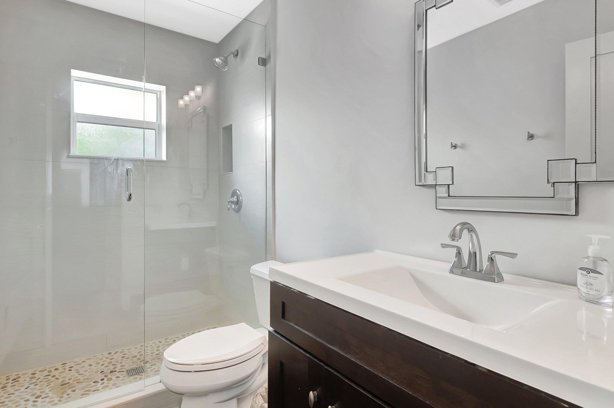 855 Berkley Street Boca Raton, FL 33487 - Photo 23 of 34 a bathroom with a sink a toilet and shower