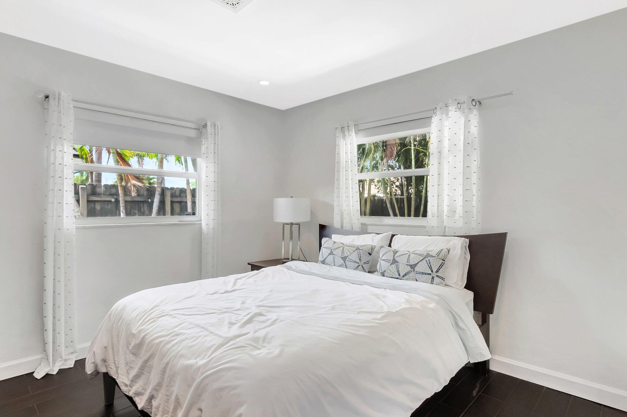 855 Berkley Street Boca Raton, FL 33487 - Photo 24 of 34 a bedroom with a bed and window