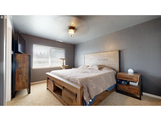 a living room with a bed furniture and a large window