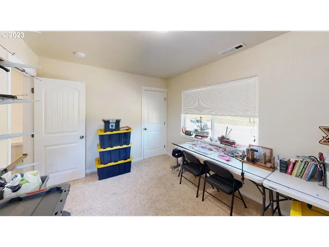 a living room with furniture and a book shelf