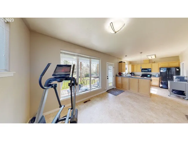 a kitchen with stainless steel appliances granite countertop a sink counter space and a refrigerator